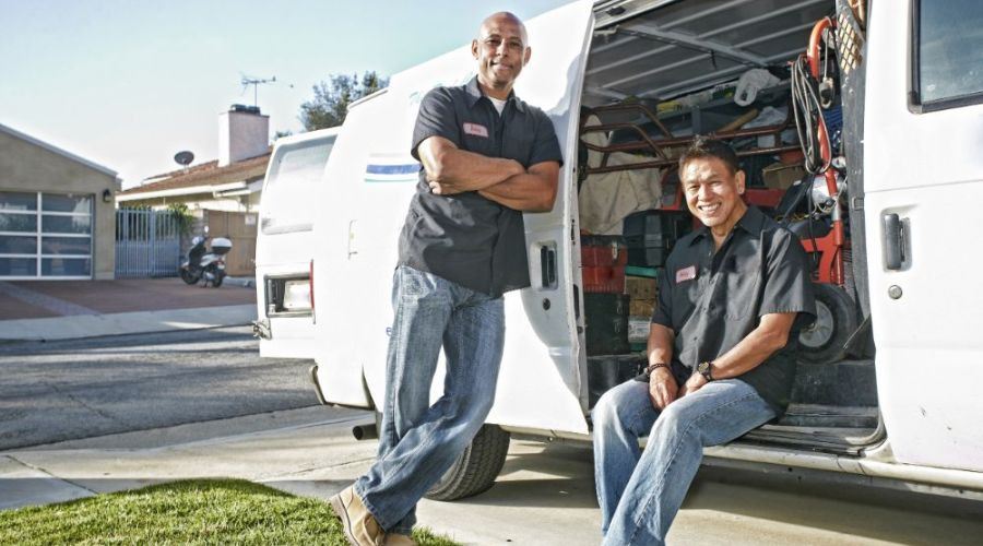2 plumbers sitting in a truck